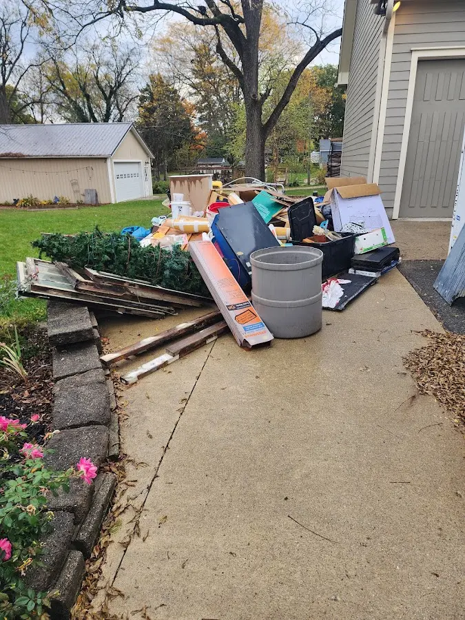 Dumpster being loaded with debris for Commercial Dumpster Rental in Reminderville